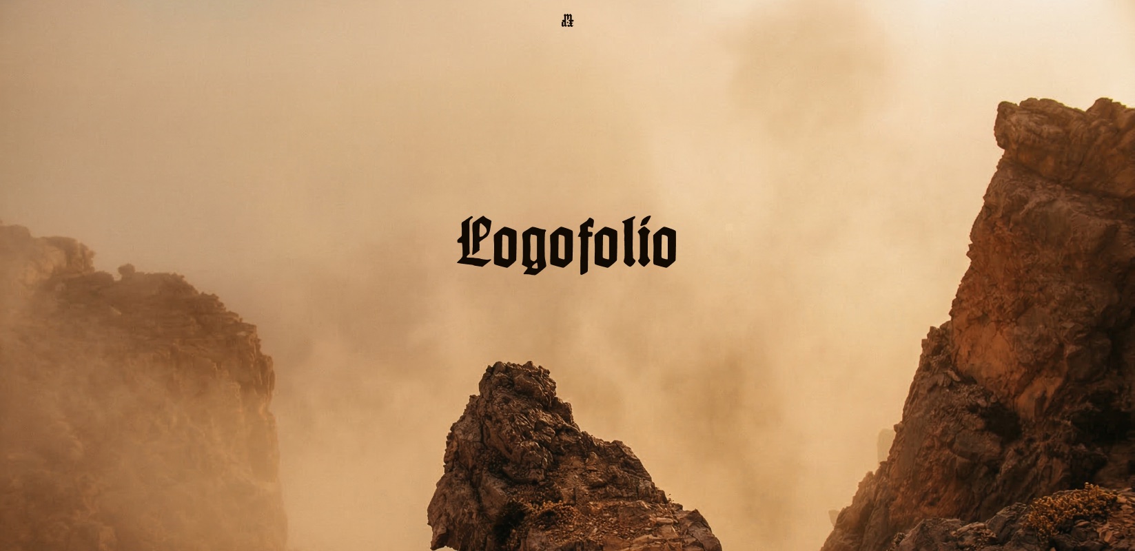 A canyon shrouded in warm, misty haze, with the Logofolio wordmark in blackletter type centered over it